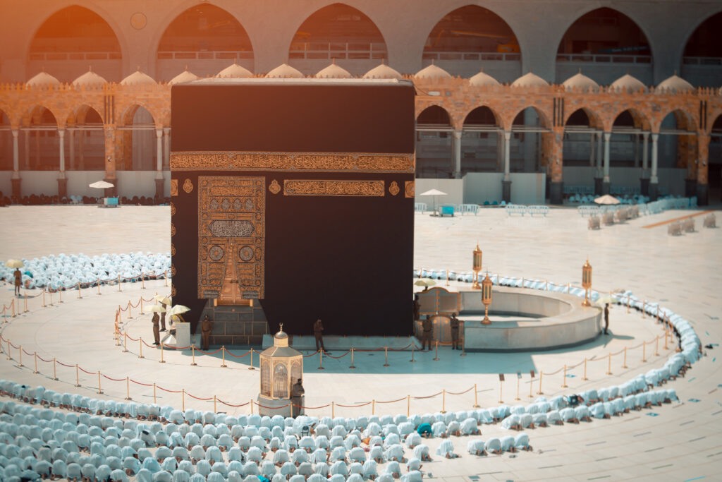 A large group of men praying around the Kaaba in al-Masjid al-Haram